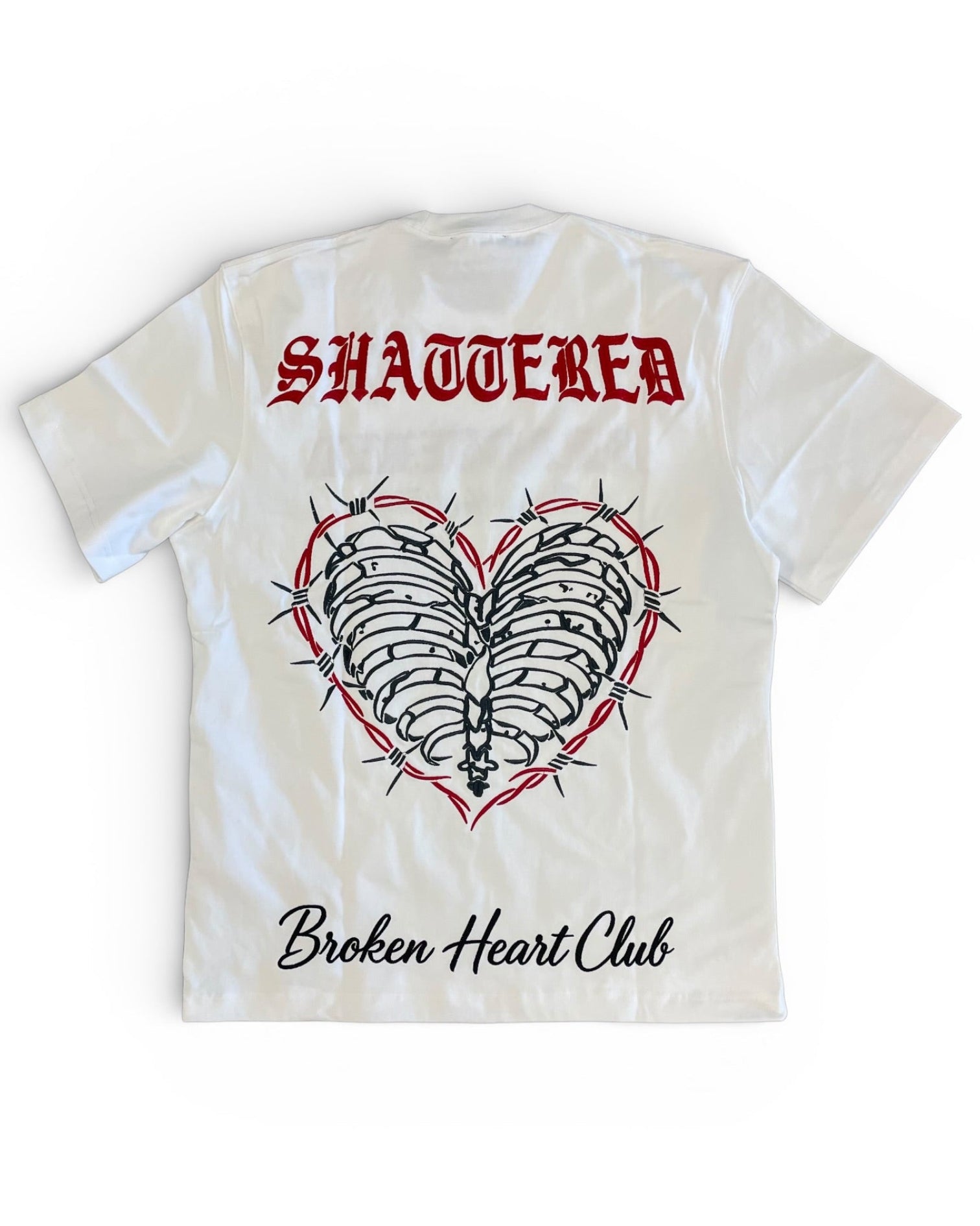 T-shirt with 'Shattered' and 'Broken Heart Club' design on a white background