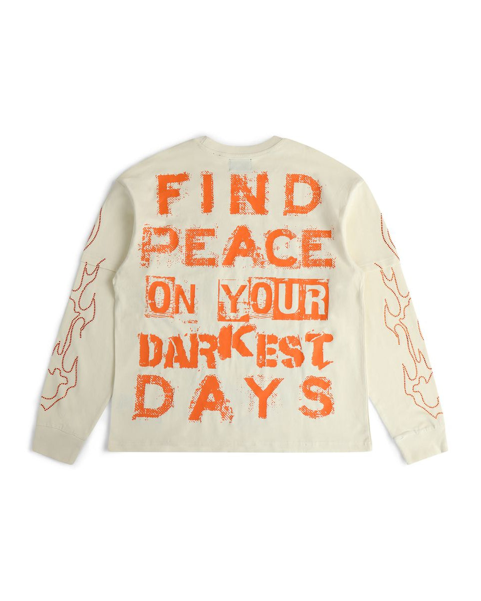 Beige sweater with orange text 'Find peace on your darkest days' on a white background