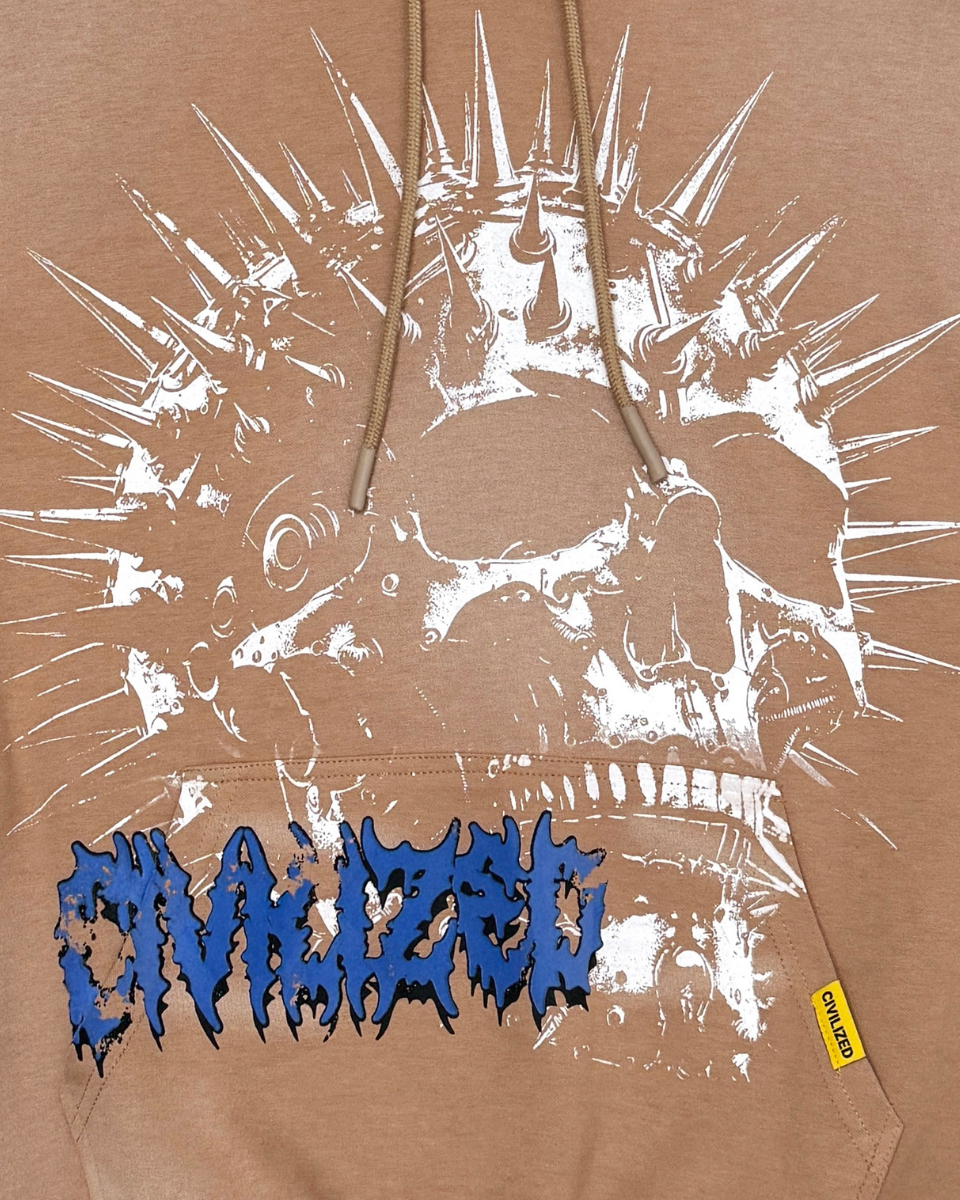 Brown hoodie with white skull design and blue text on a beige background