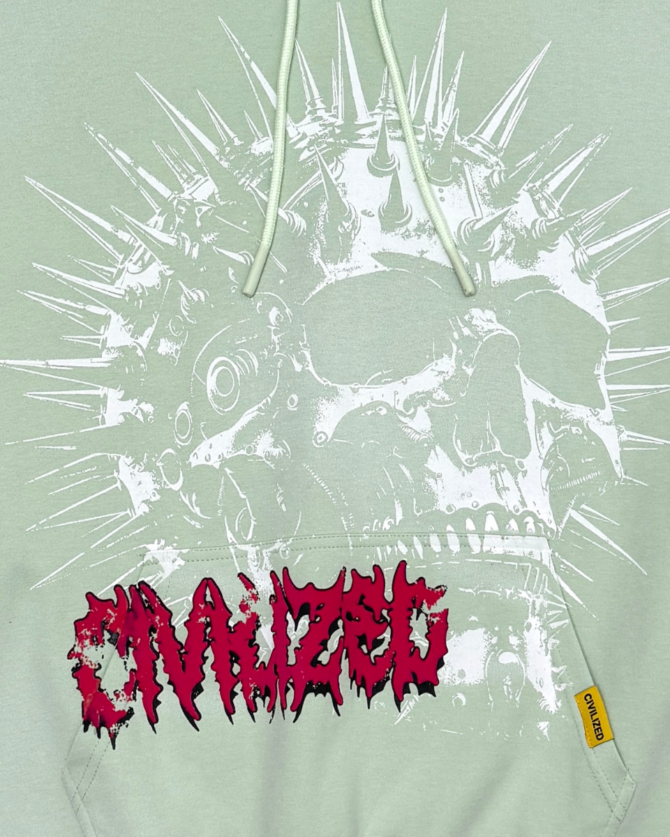 Light green hoodie with a skull design and red text on a light gray background