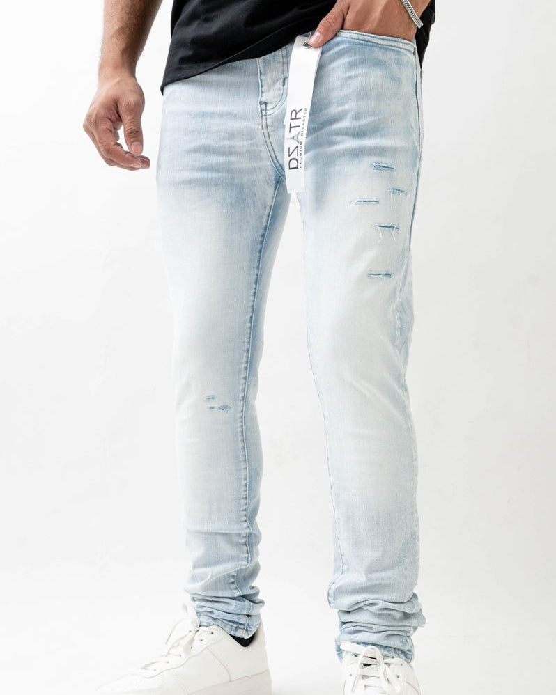 Light blue distressed jeans worn by a person on a white background