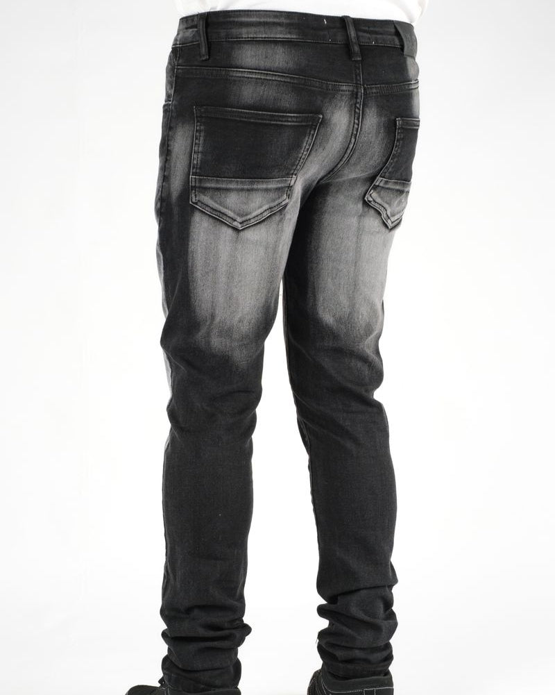 Black distressed jeans on a white background