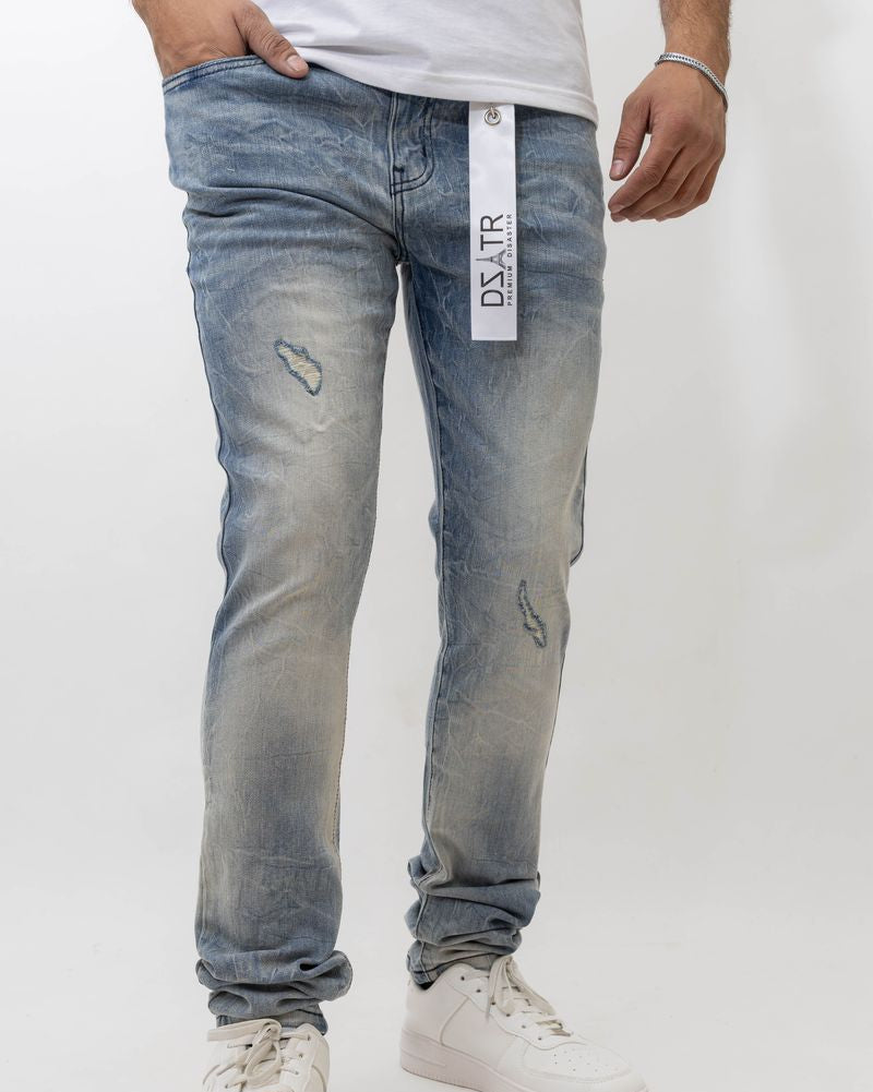 Person wearing light blue distressed jeans with a visible brand label on a white background