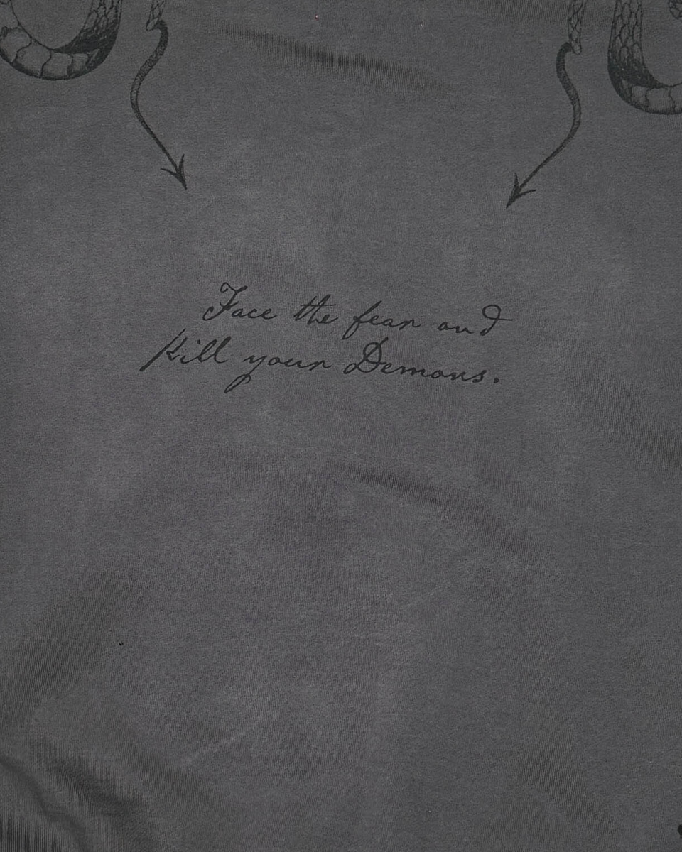 Dark gray t-shirt with snake design and motivational quote on fabric texture