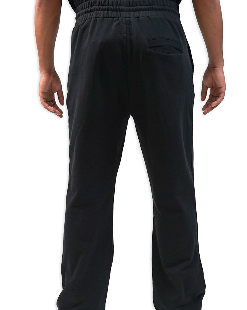 Black pants worn by a person on a white background