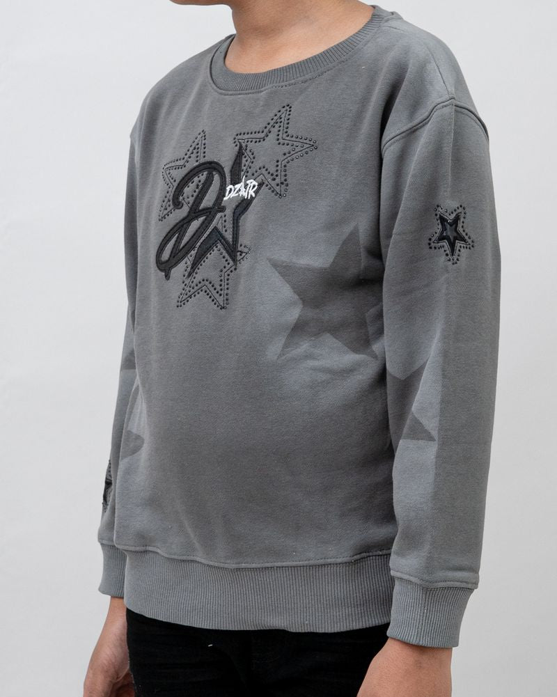 Gray sweatshirt with star designs on a plain background