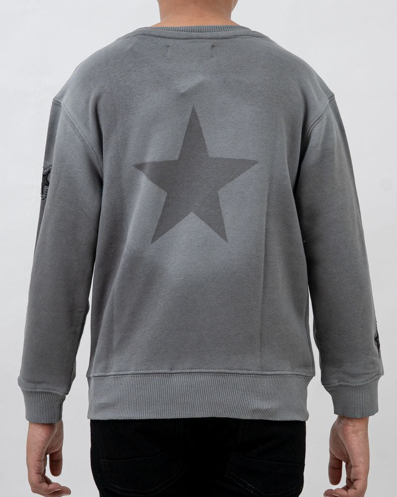 Gray sweatshirt with a star design on the back worn by a person against a white background