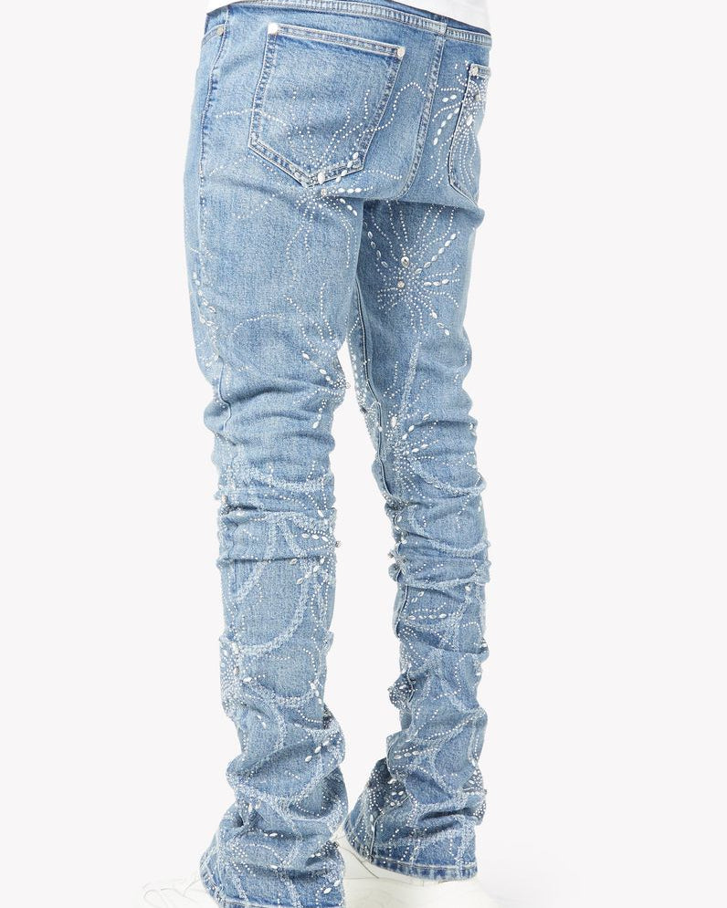 Light blue jeans with rhinestone embellishments on a white background