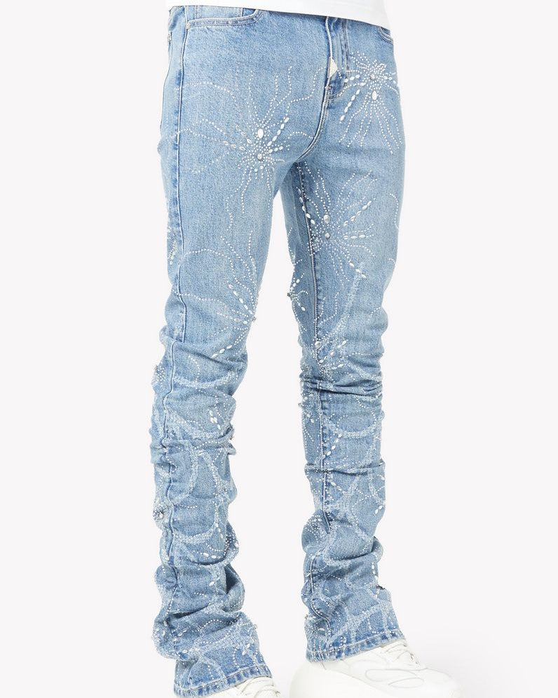 Light blue distressed jeans worn with white sneakers on a white background