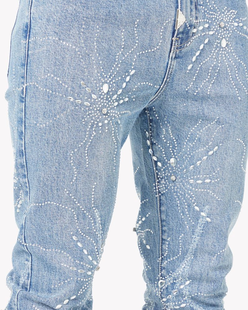 Light blue jeans with decorative patterns on a white background