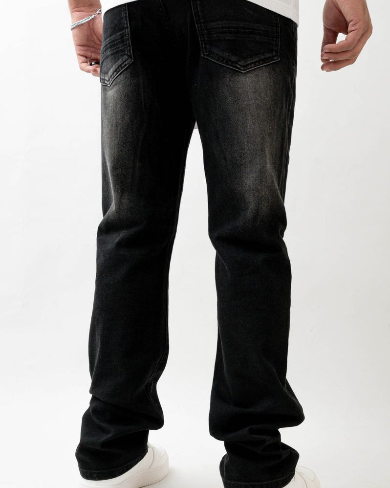 Person wearing black jeans on a white background