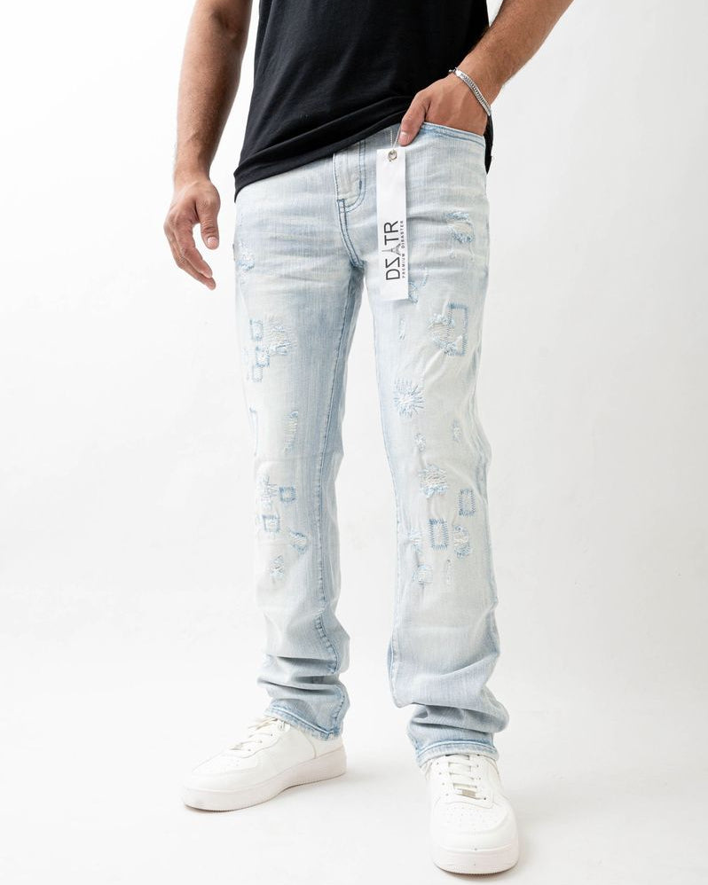 Person wearing light blue jeans with a visible brand label on a white background