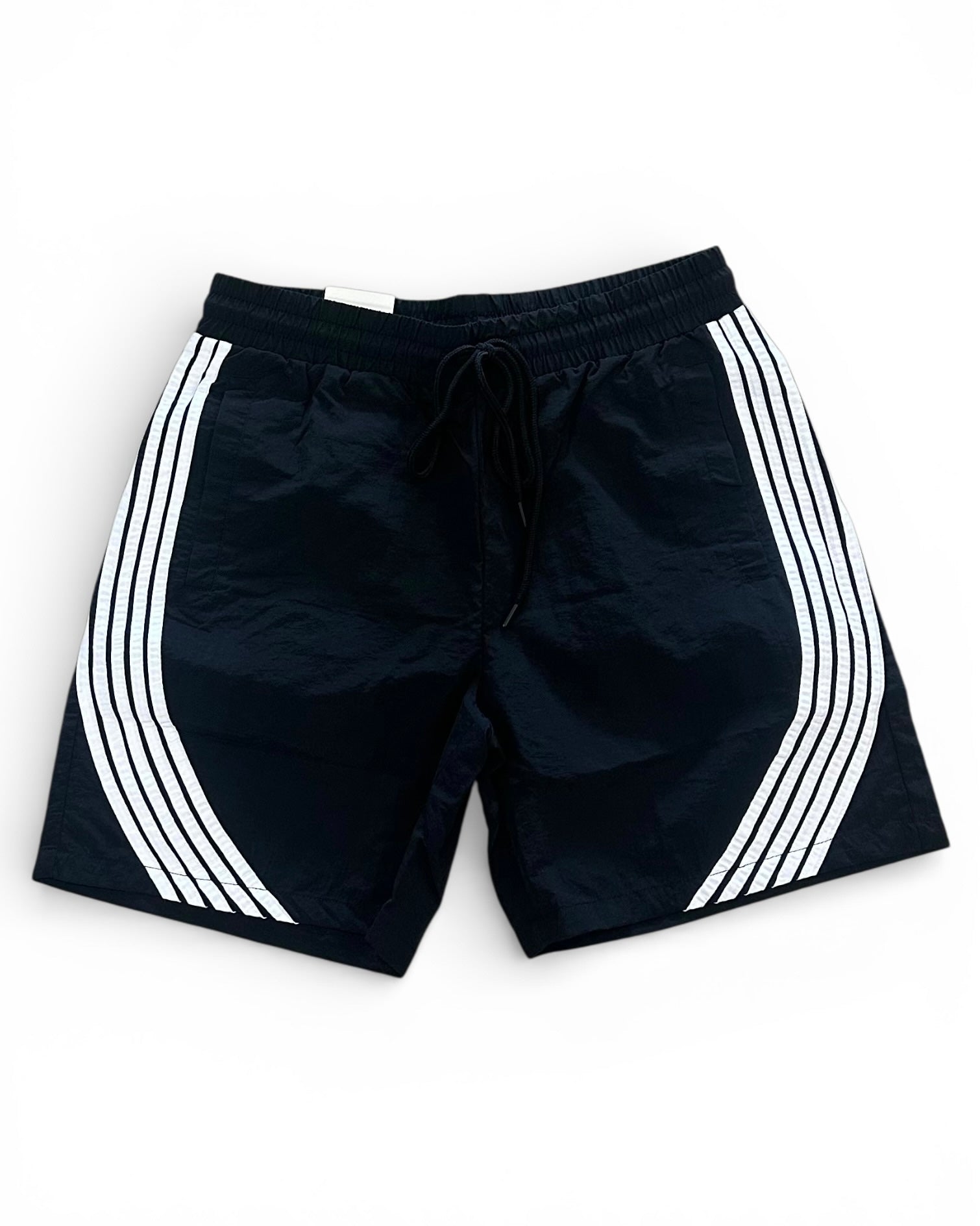 Black shorts with white stripes on a white background