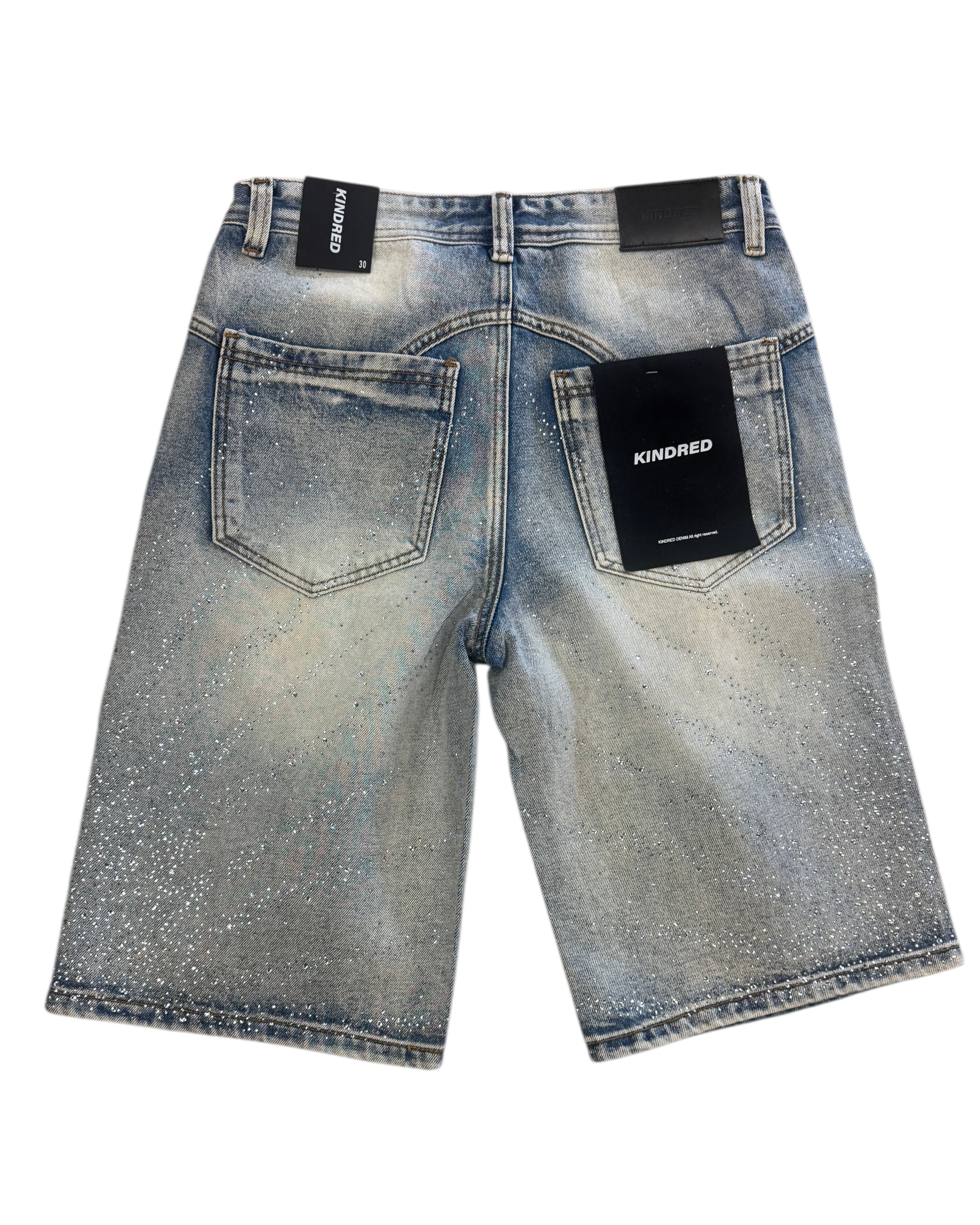 Blue denim shorts with 'Kindred' branding on a white background