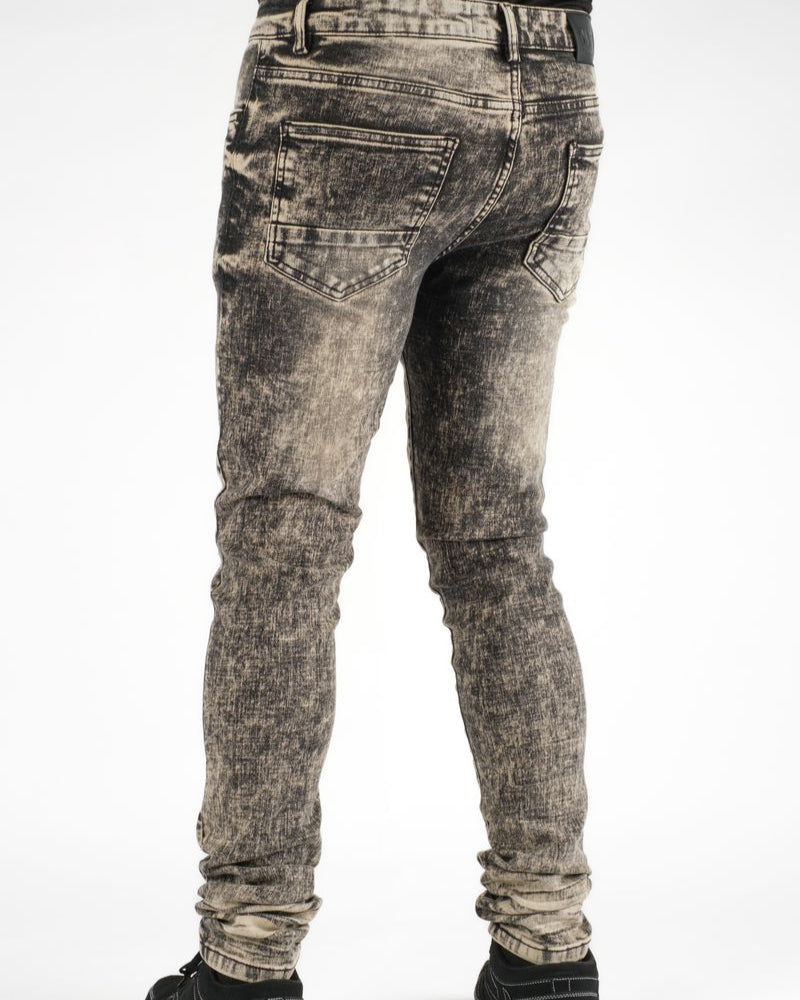 Distressed black jeans on a white background