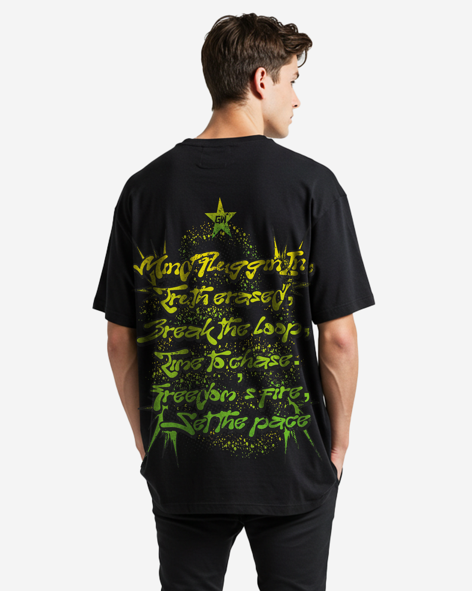Person wearing a black t-shirt, back shown, with green text and graphics on the back, standing against a white background