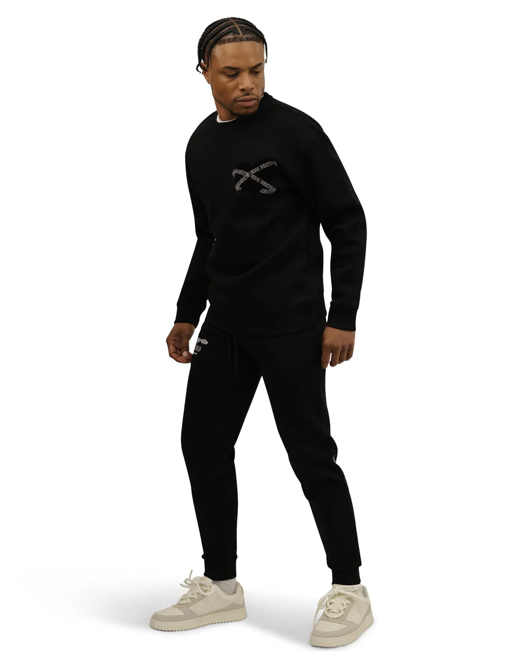 Person wearing a black outfit with a logo on a white background