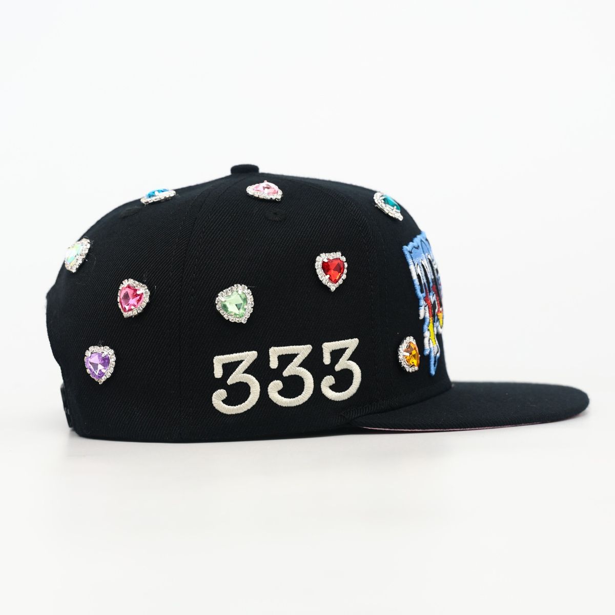 Black cap with colorful gemstones and '333' on a white background