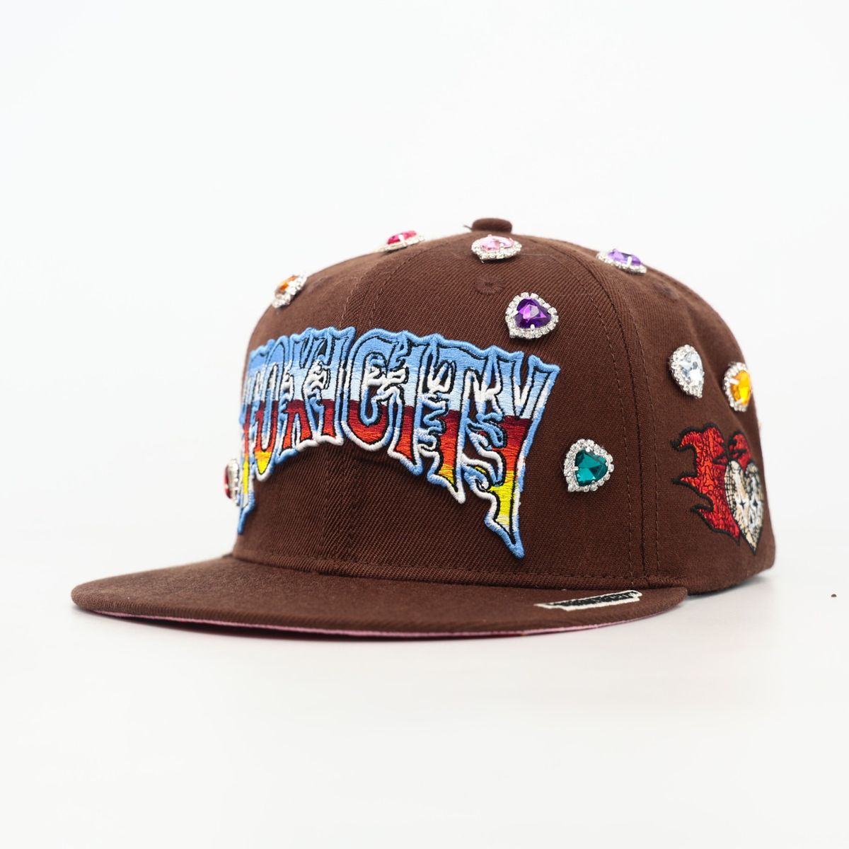Brown cap with colorful text and decorative elements on a white background