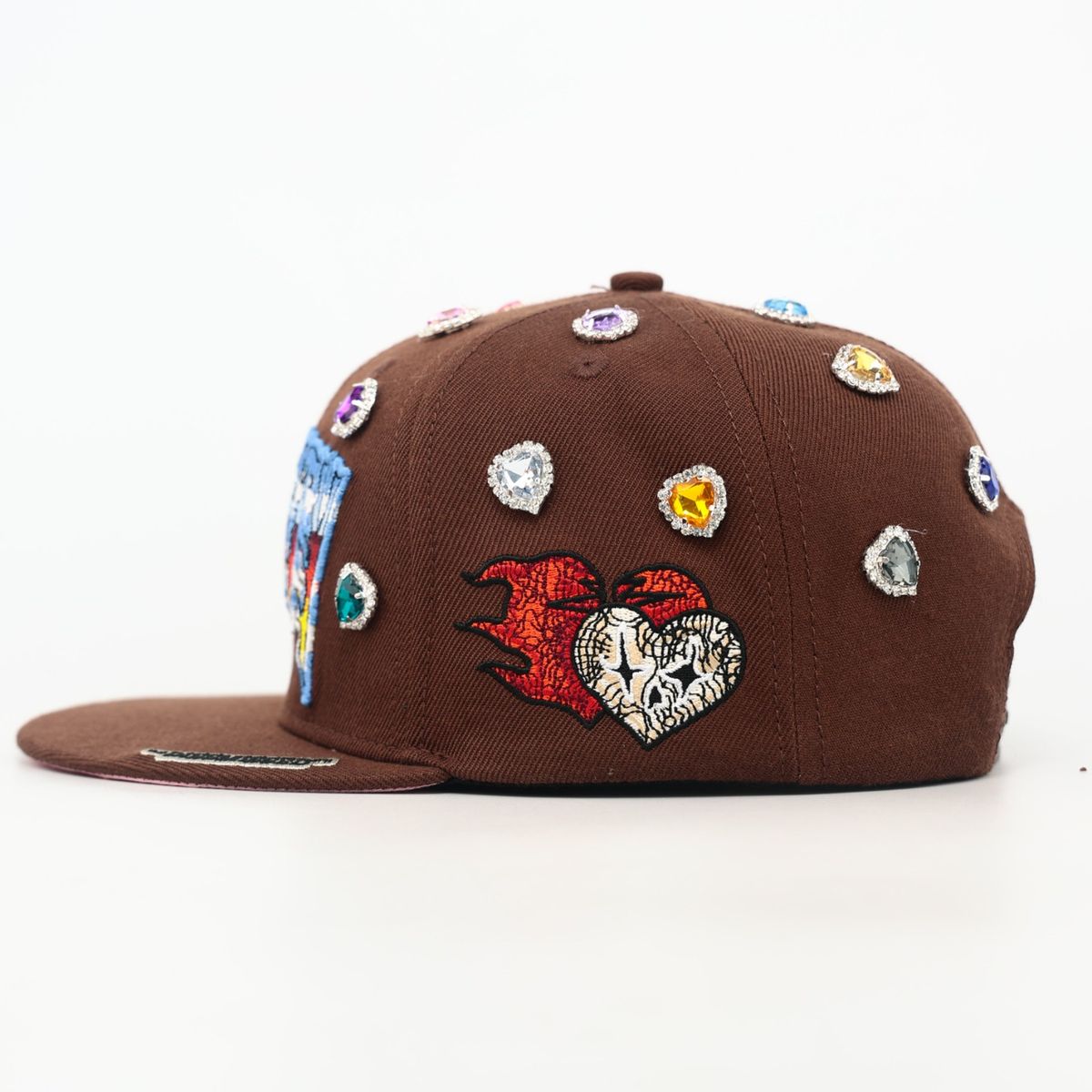 Brown cap with colorful embellishments on a white background