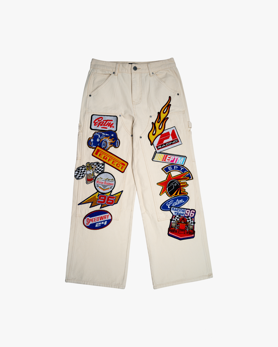 Beige pants with various patches on a white background