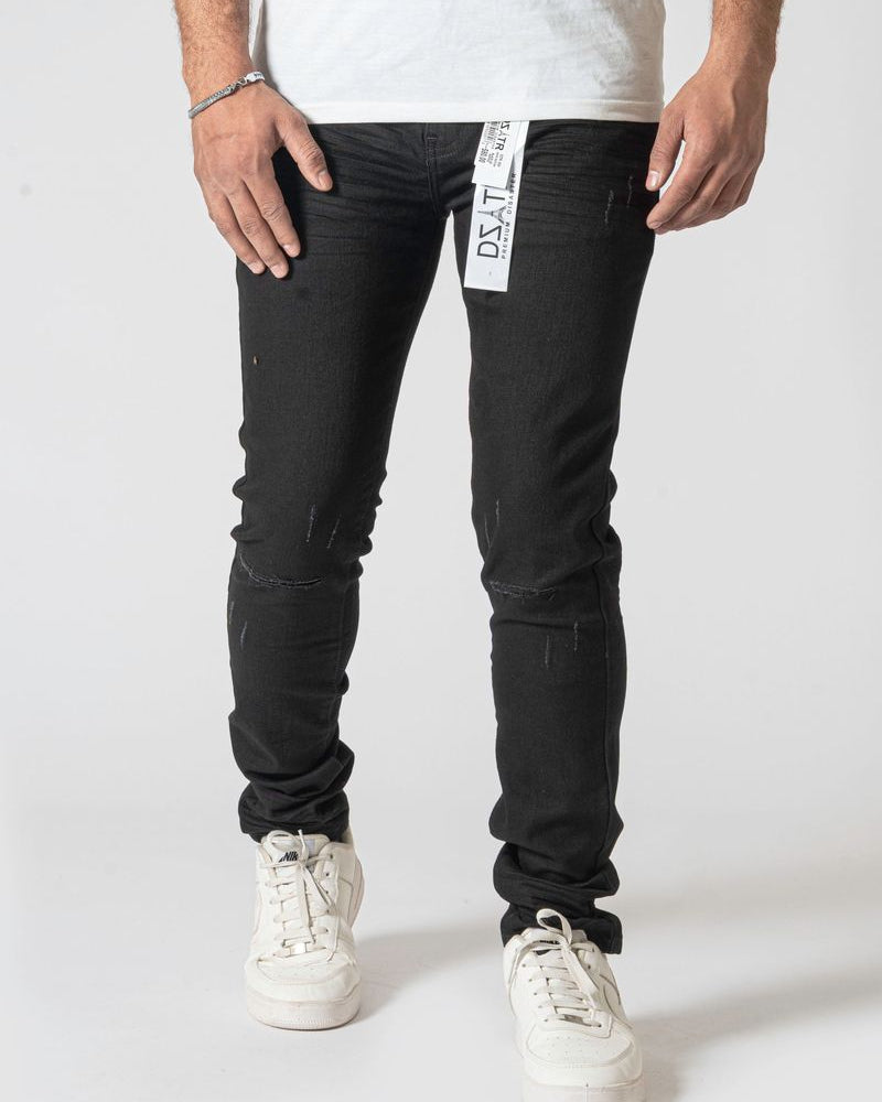 Person wearing black jeans with a visible brand label on a white background