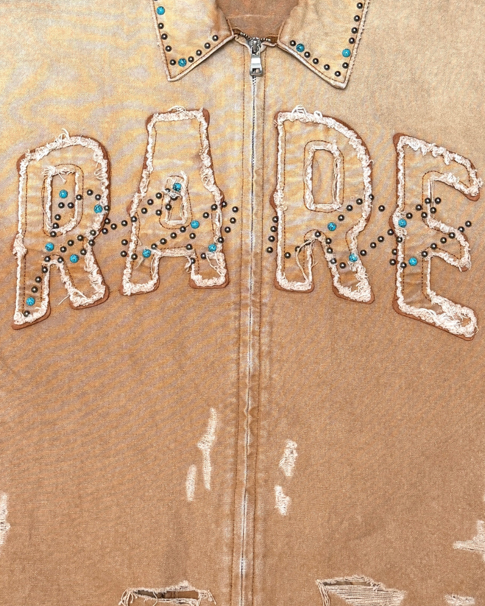 Brown jacket with 'RARE' text in white sequins and beads