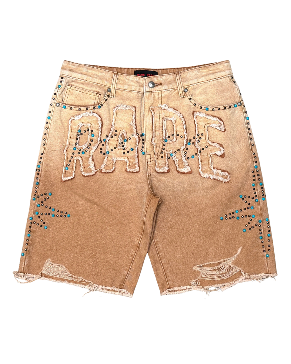 Beige denim shorts with 'RARE' embellishments on a white background