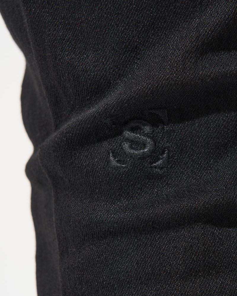 Close-up of a black fabric with a logo on a white background