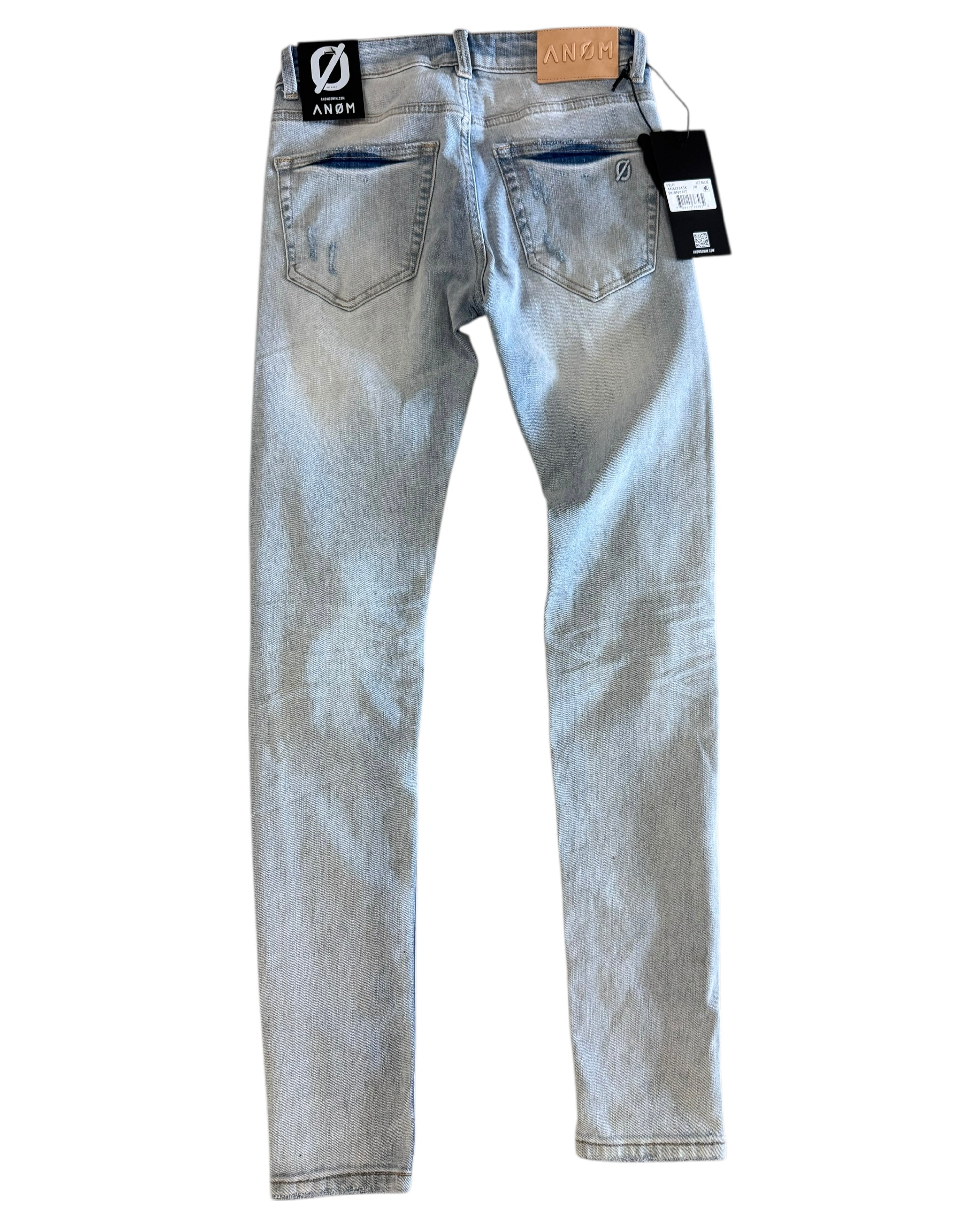 Light blue jeans with tags on a white background