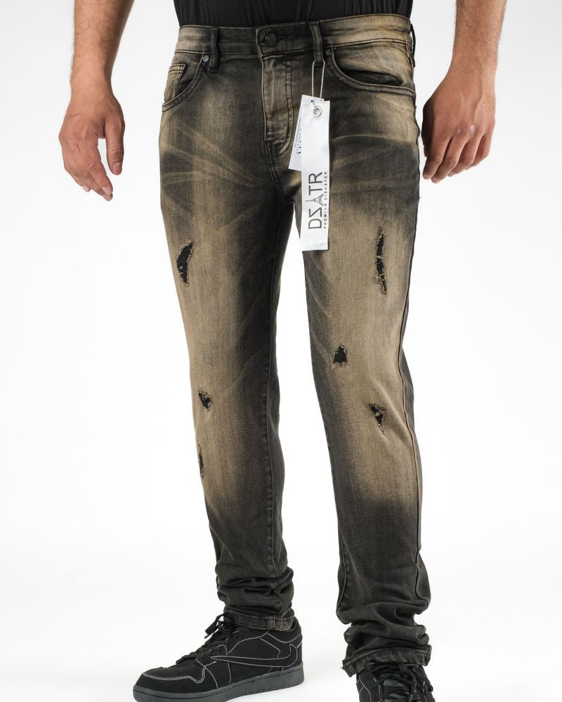 Distressed black jeans with a brand tag on a white background