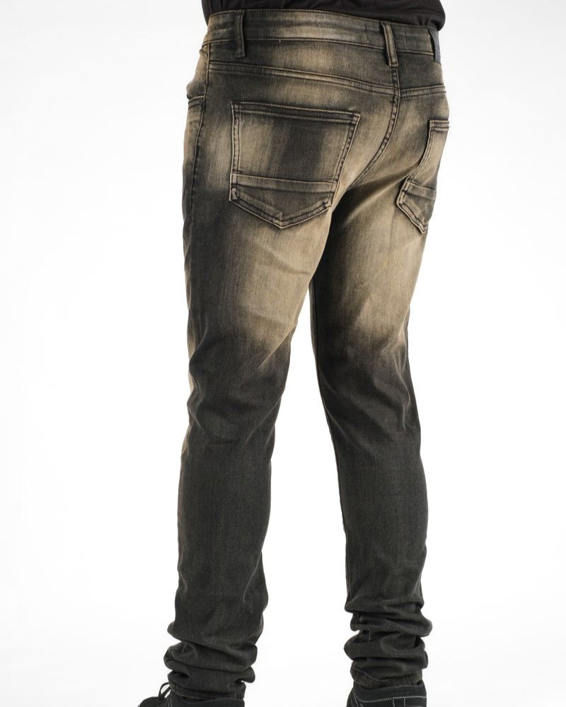 Dark jeans worn by a person on a white background