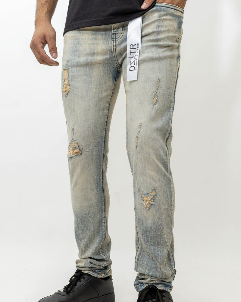 Person wearing distressed light blue jeans with a brand logo on a white background