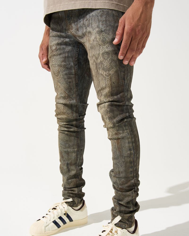 Person wearing distressed gray jeans and white Adidas sneakers on a white background