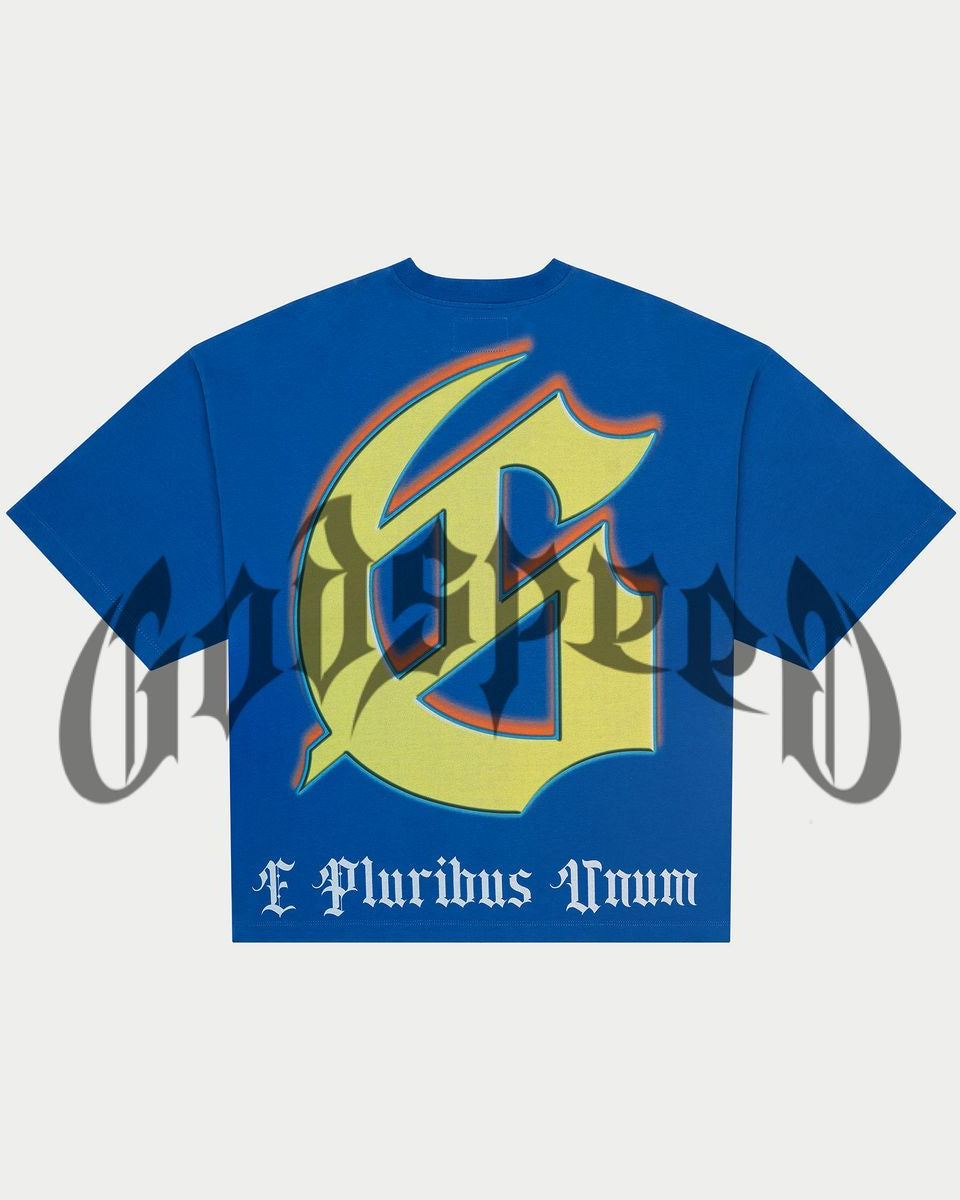 Blue t-shirt with a large yellow and red graphic design on a light gray background