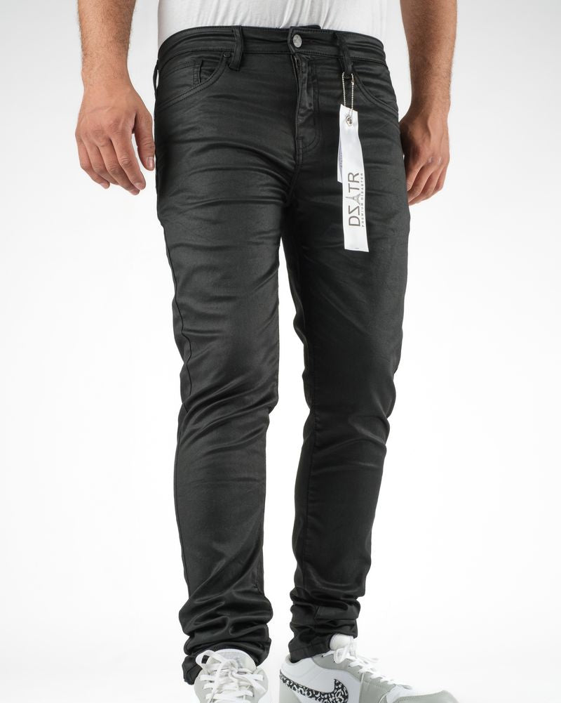 Person wearing black jeans with a visible brand tag on a white background