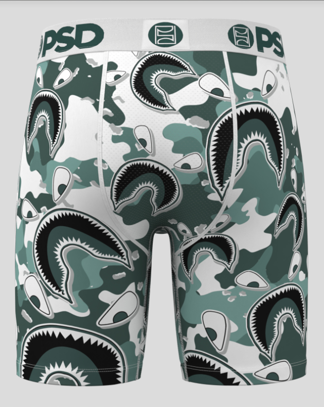 Green camouflage-patterned boxer briefs with shark design on a light gray background