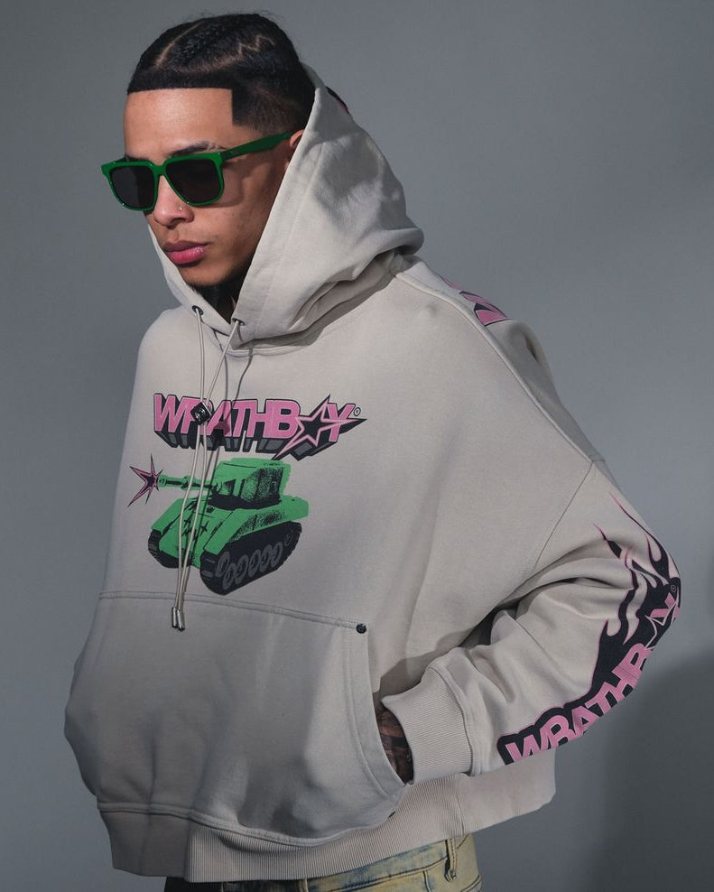 Person wearing a gray hoodie with colorful graphics and text, standing against a plain background.
