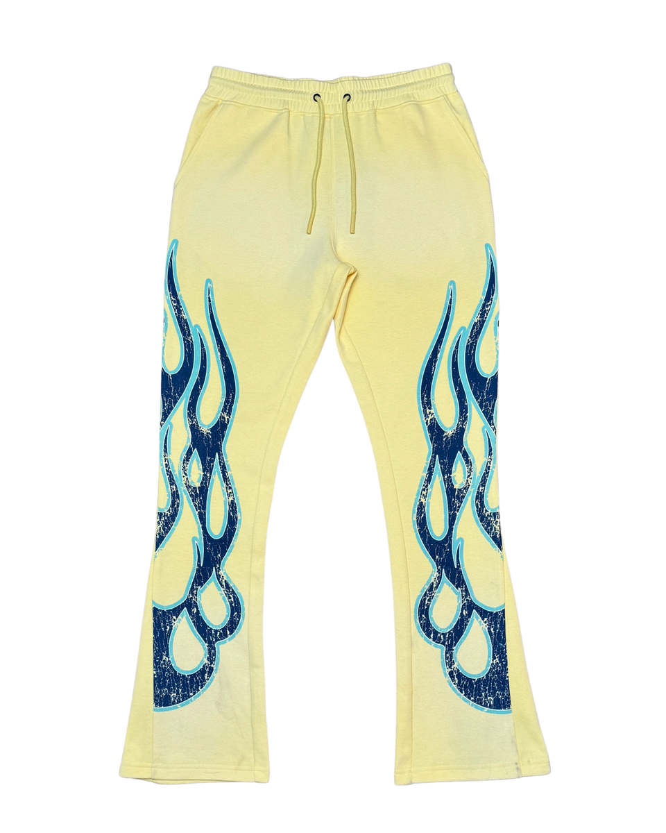 Yellow sweatpants with blue flame designs on a white background