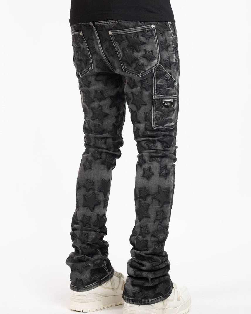 Black star camouflage jeans worn by a person on a white background
