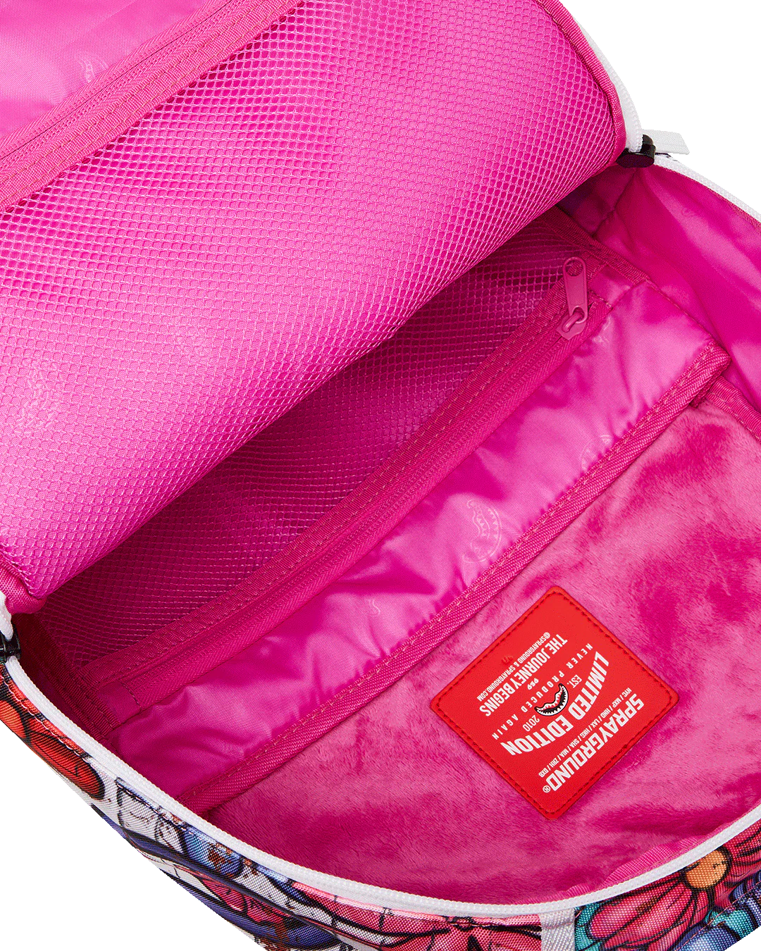 Pink interior of a bag with a floral pattern inside, featuring a red label.