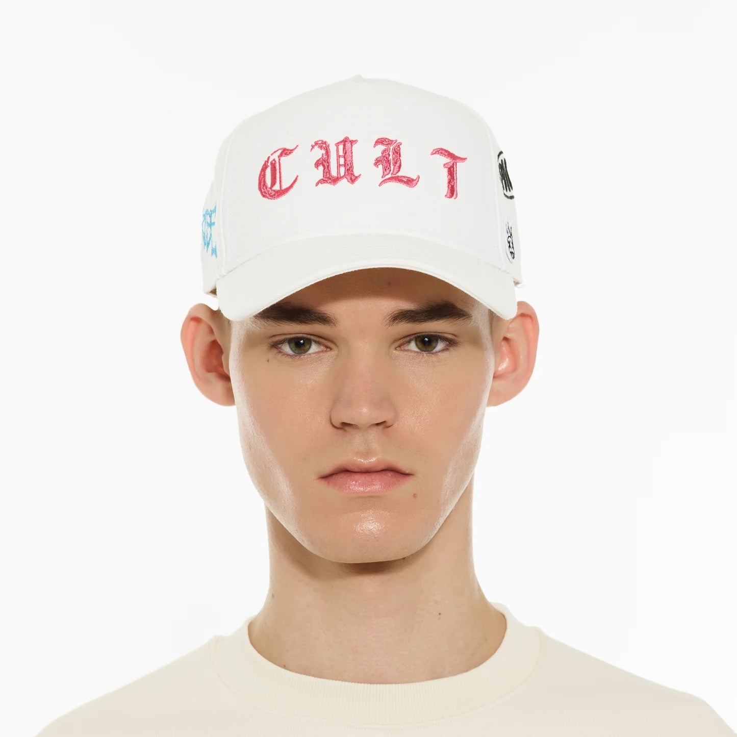 Person wearing a white cap with red text on a white background
