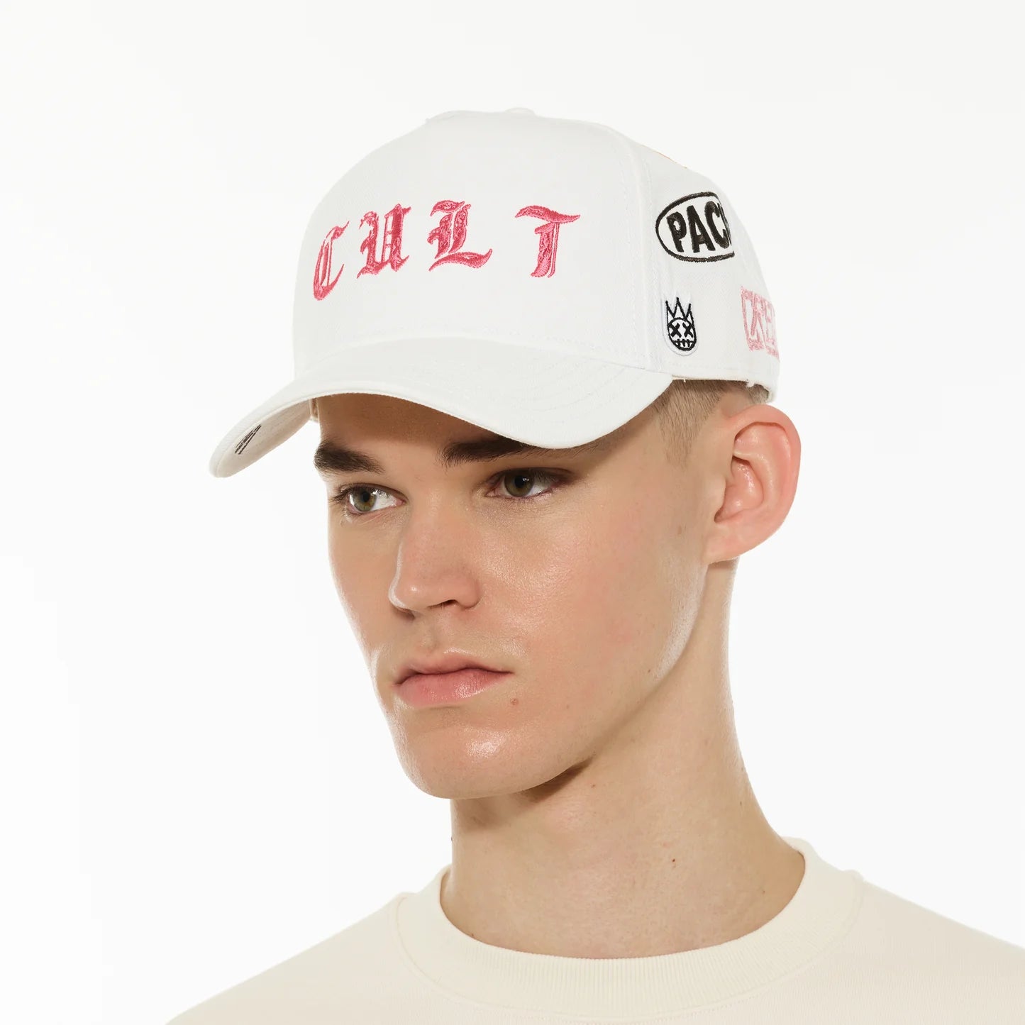 Person wearing a white cap with red and black text on a white background