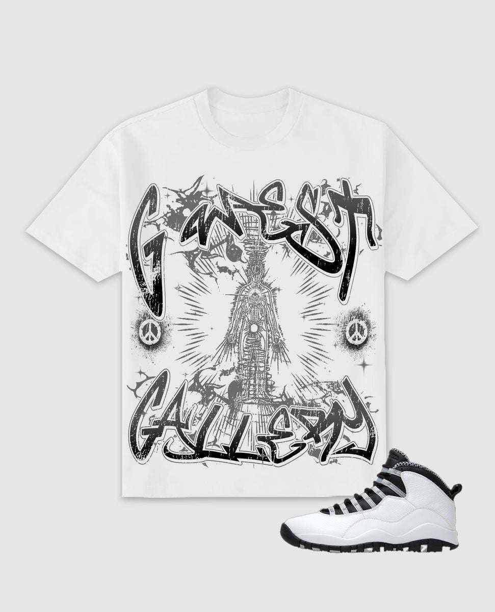 White t-shirt with black graphic design and a white sneaker on a light gray background