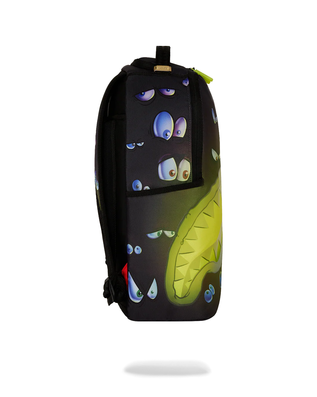 sprayground backpack with pairs of eyes all over and a neon yellow shark mouth design