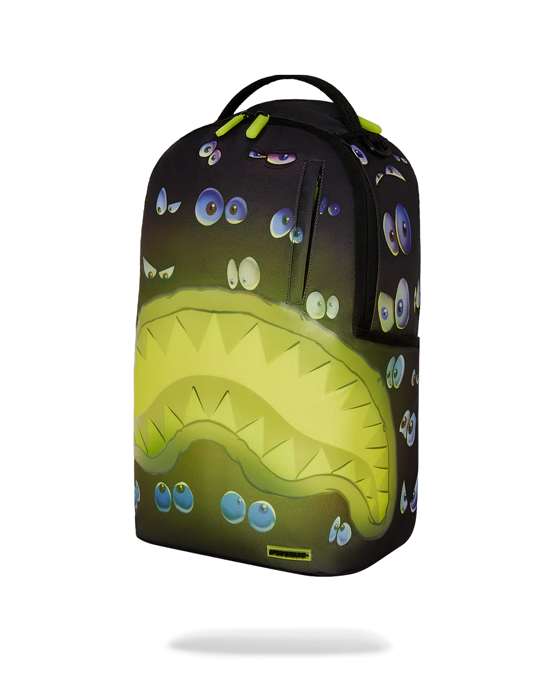 sprayground backpack with pairs of eyes all over and a neon yellow shark mouth design