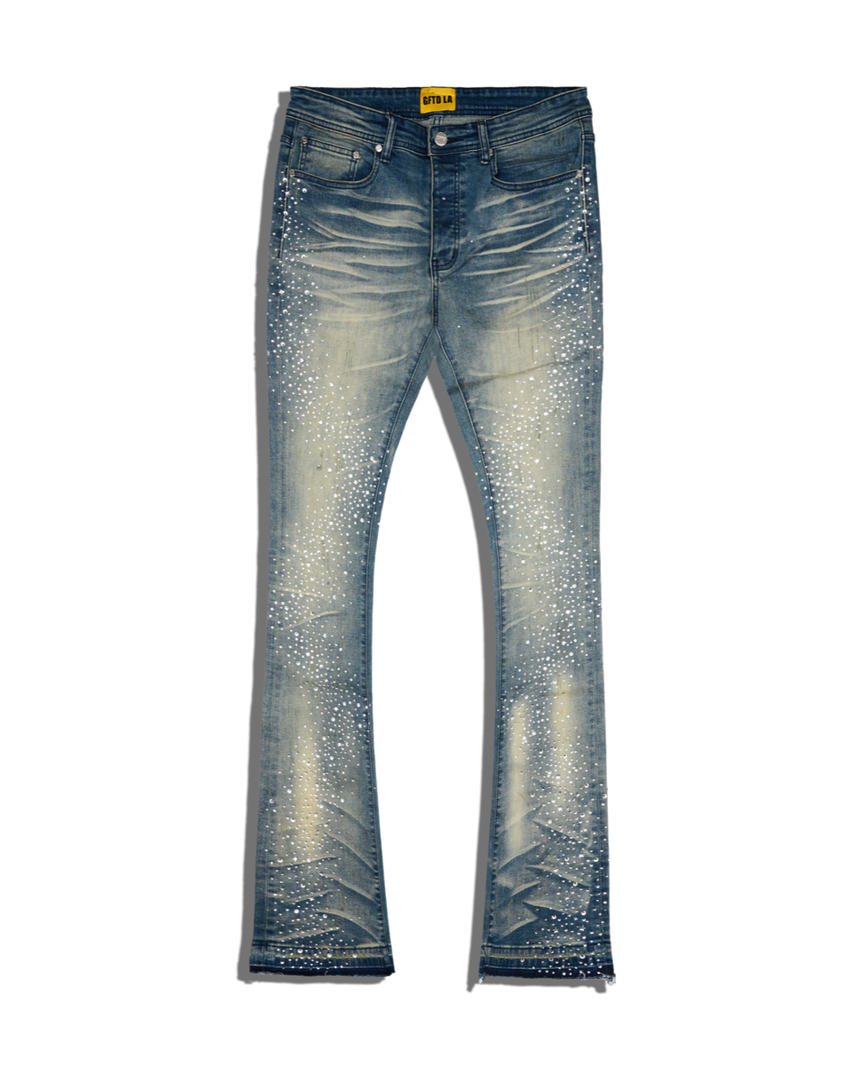 Blue jeans with rhinestone embellishments on a white background