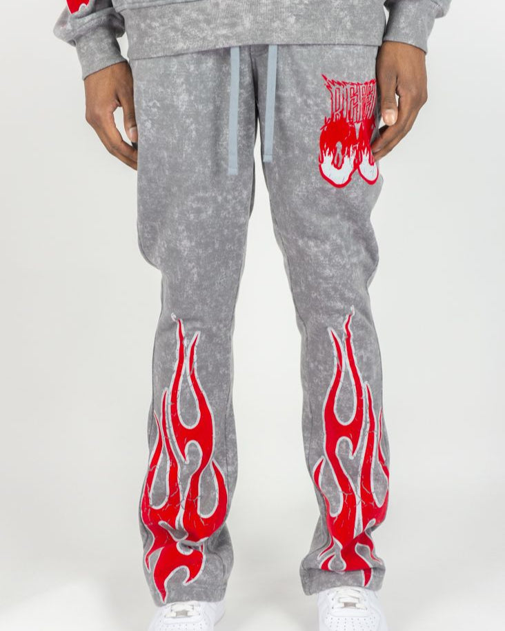 Gray sweatshirt and pants with red flame designs on a white background