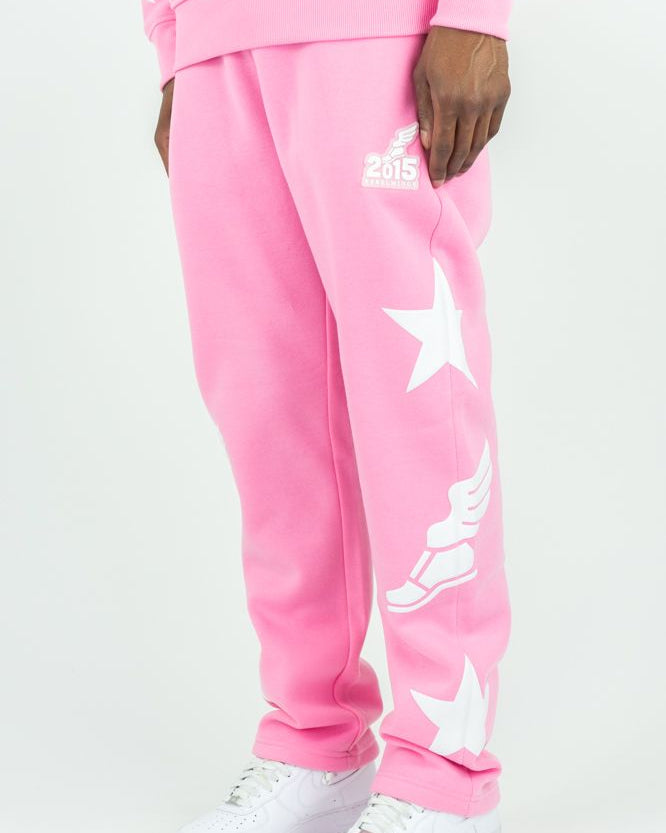 Pink sweatpants with star designs and '2015' text on a white background