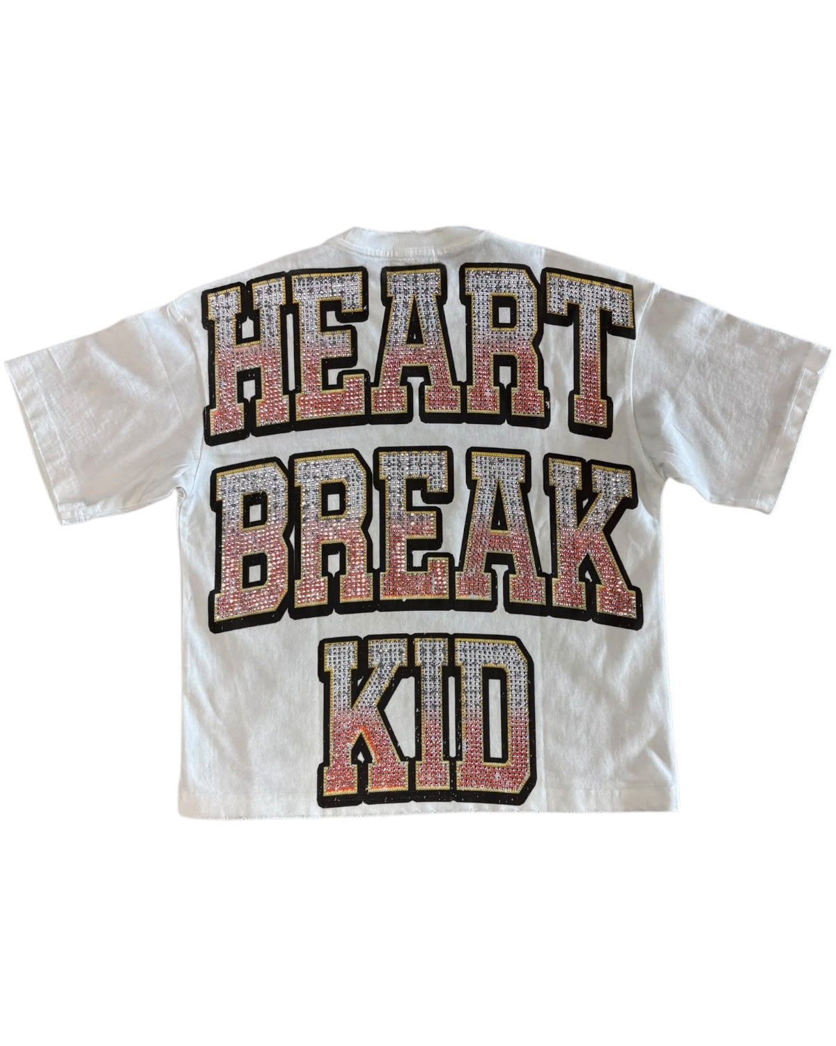 White t-shirt with 'HEART BREAK KID' text in rhinestone letters on a white background